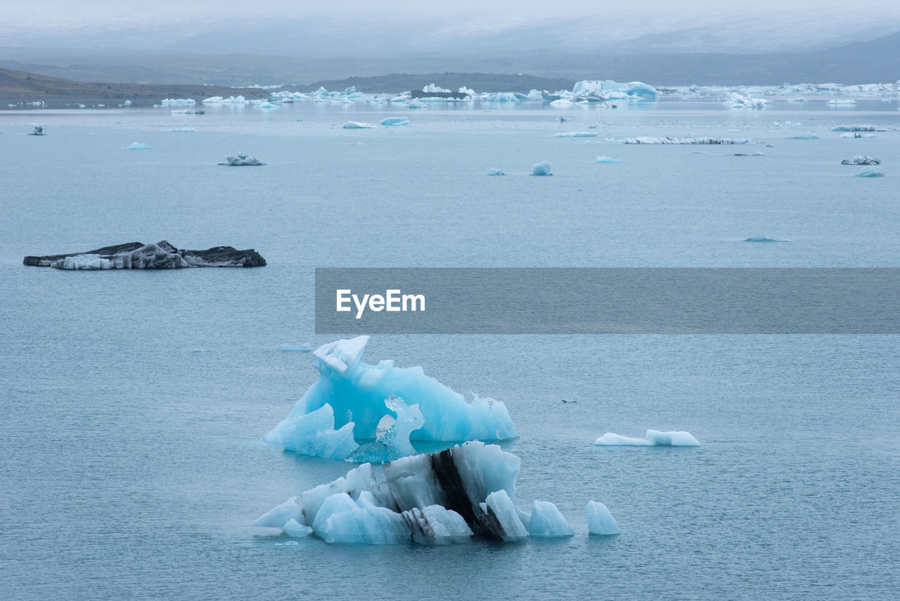 Floating icebergs in jokulsarlon glacial lagoon, iceland. global warming