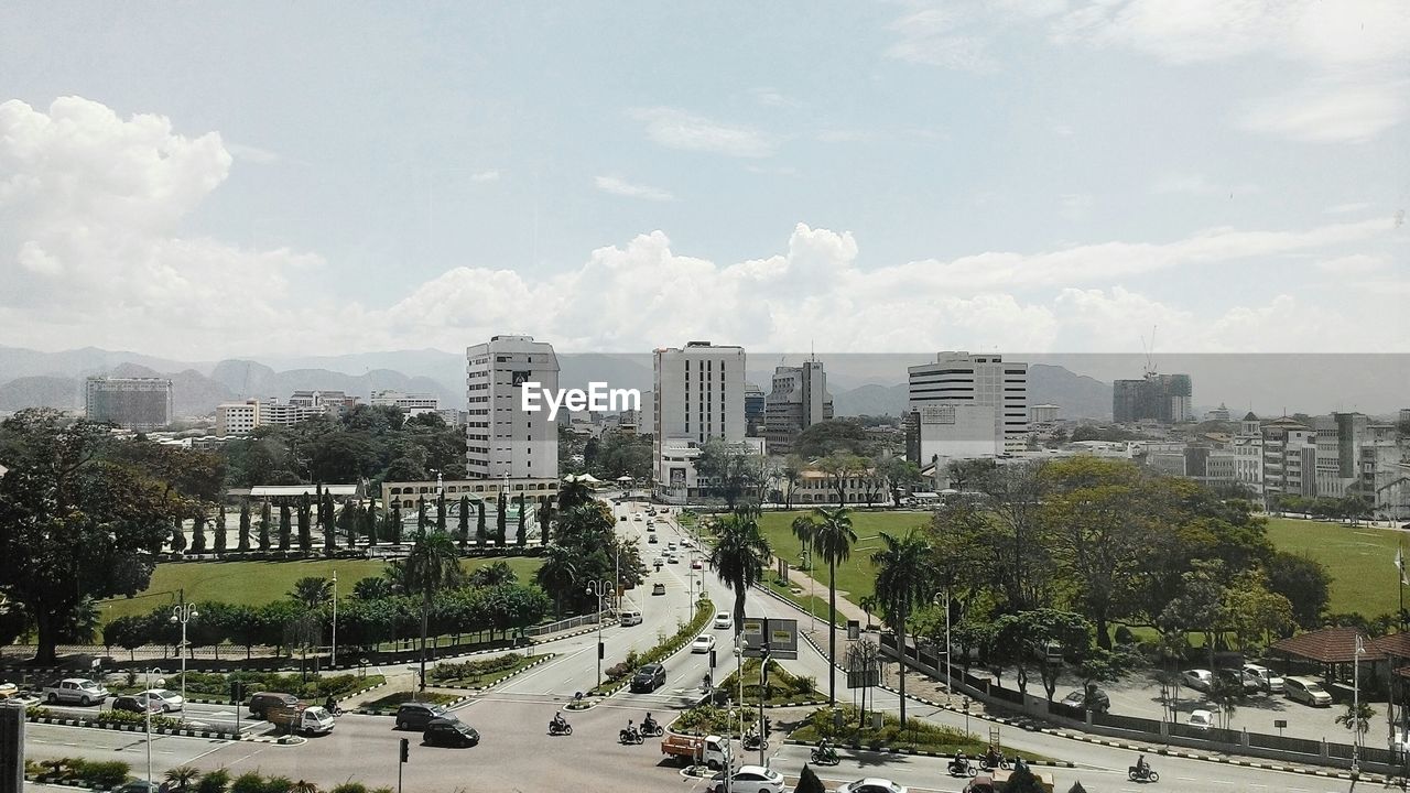 HIGH ANGLE VIEW OF CITY STREET AND BUILDINGS AGAINST SKY