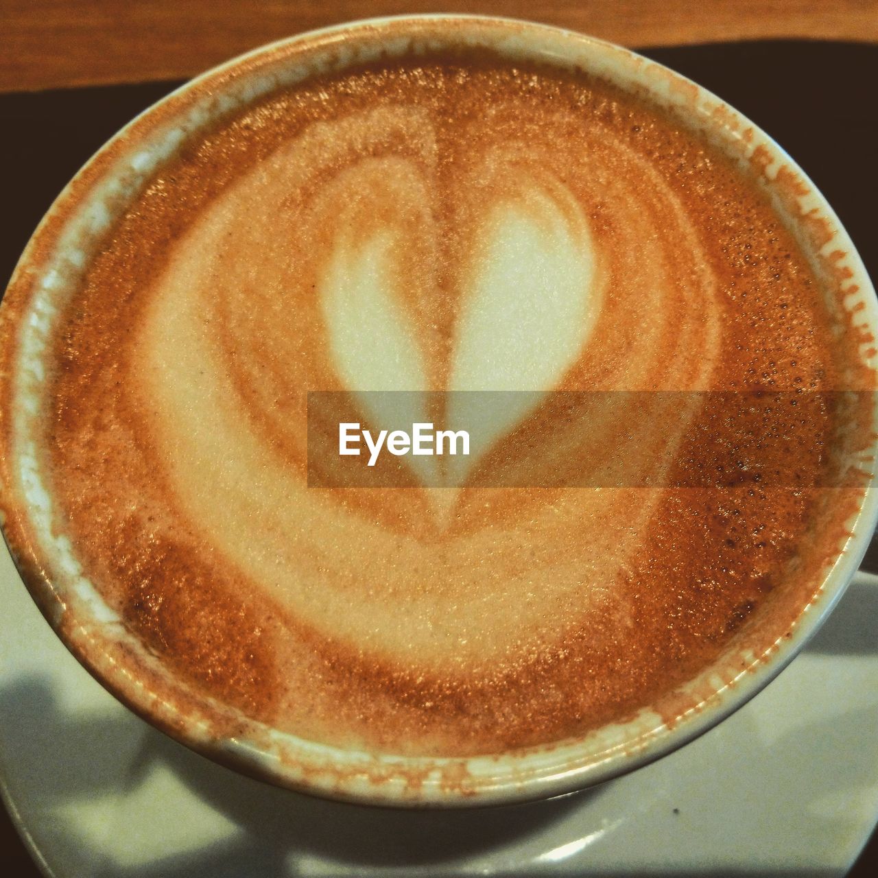 CLOSE-UP OF CAPPUCCINO ON COFFEE