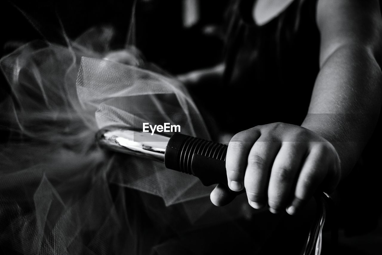 Midsection of girl holding handle