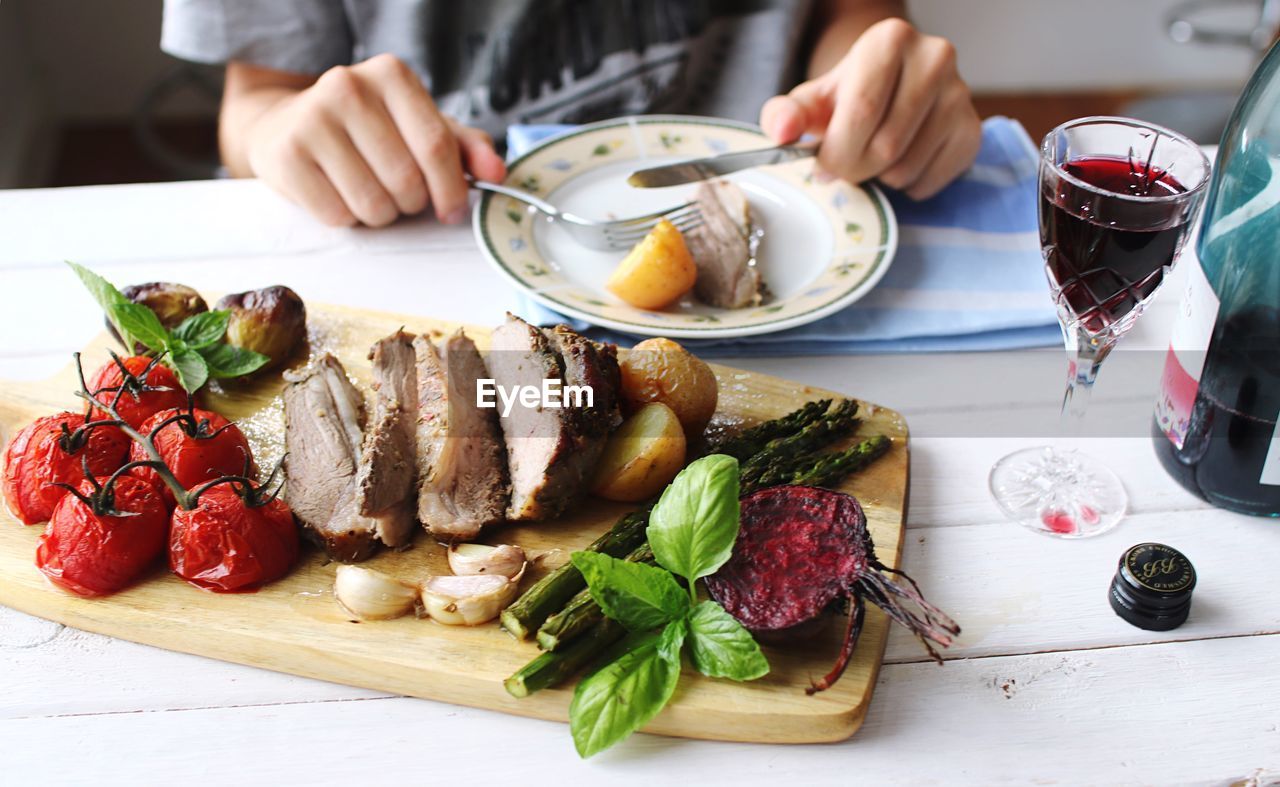 Close-up of hand with meal on table