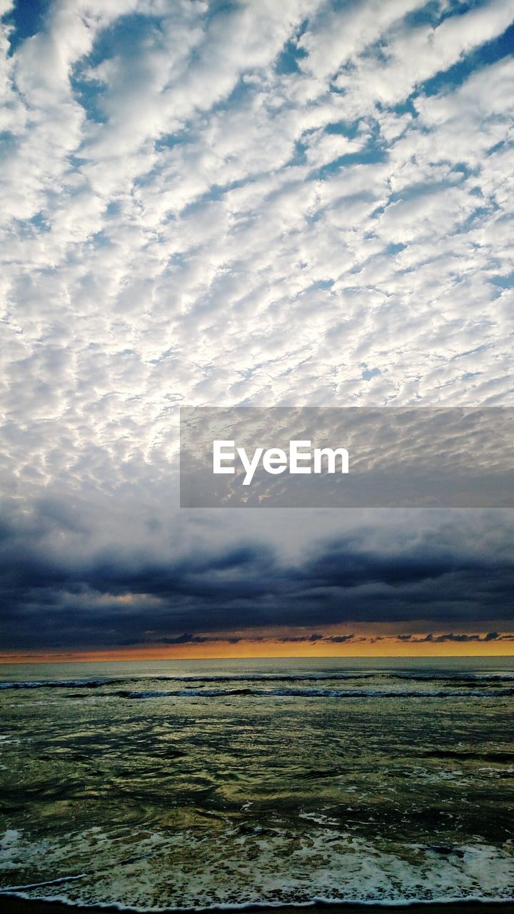 Scenic view of sea against cloudy sky