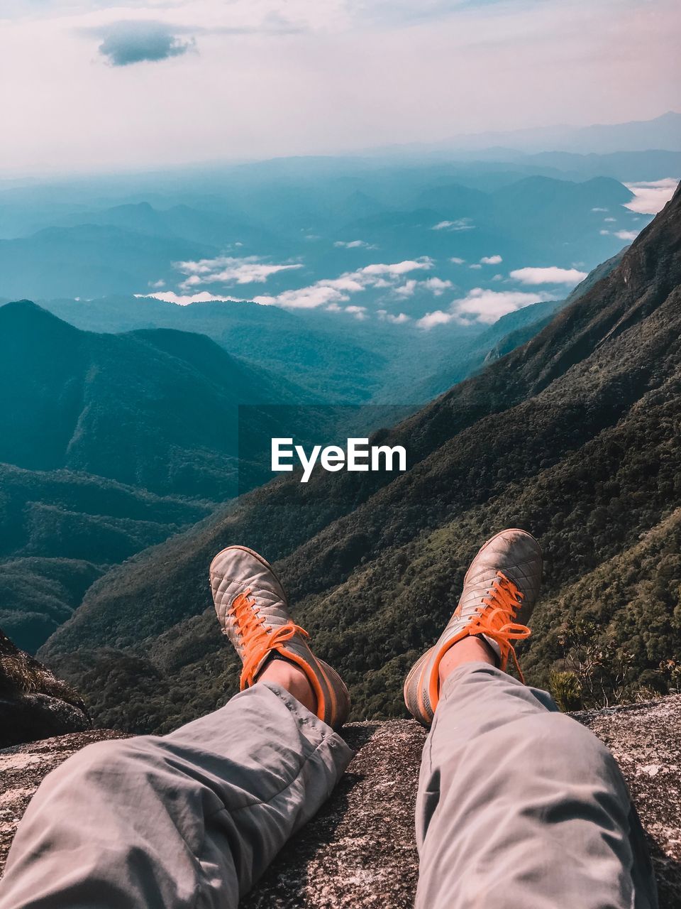 Low section of man wearing shoes on mountain