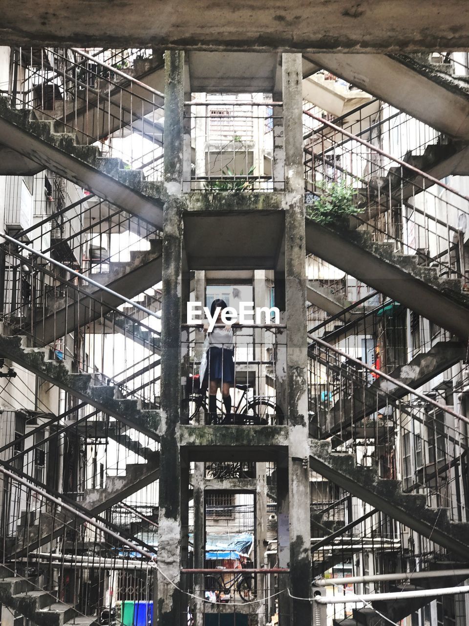 Woman standing on staircase of building