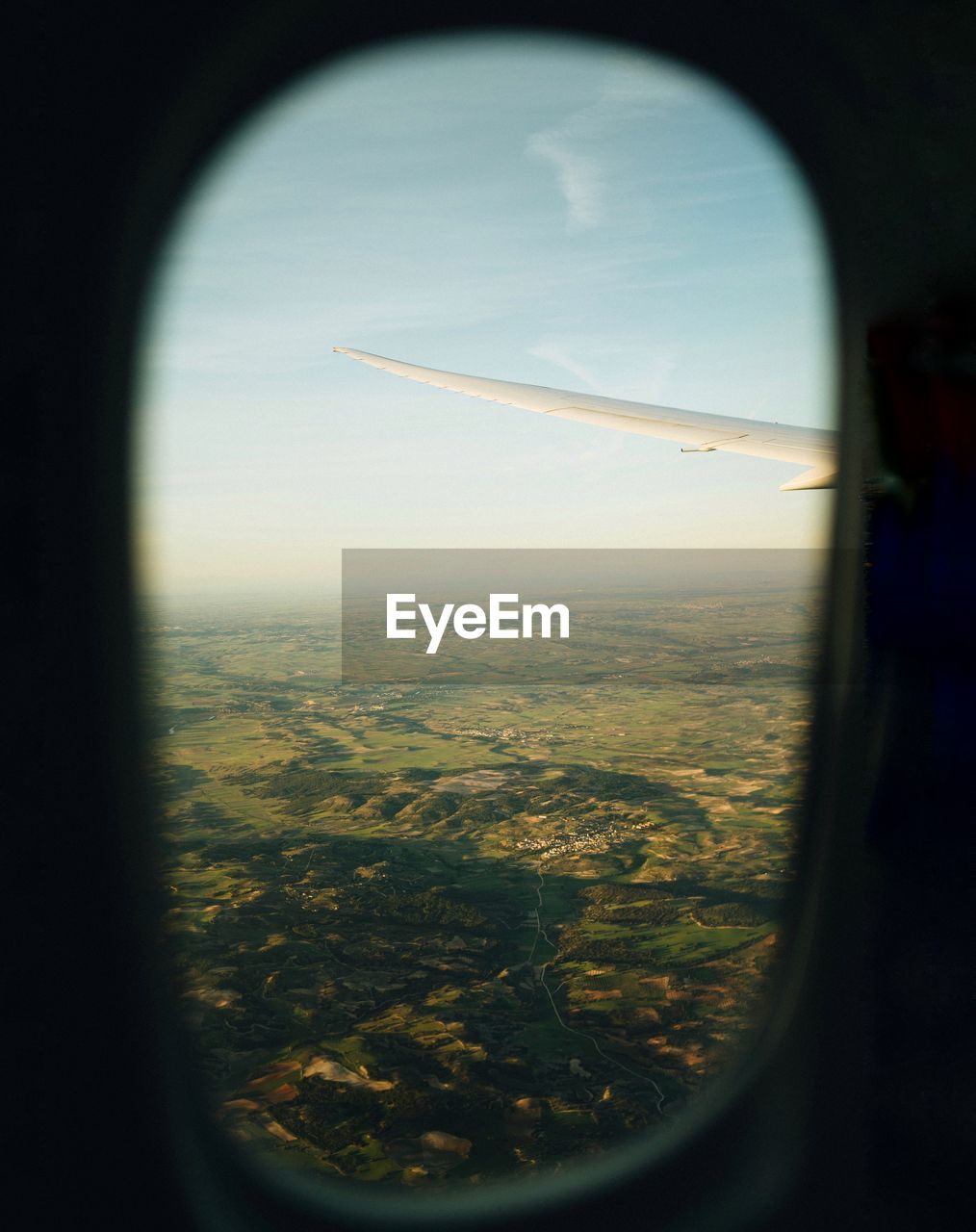 AERIAL VIEW OF CITYSCAPE SEEN THROUGH AIRPLANE WINDOW