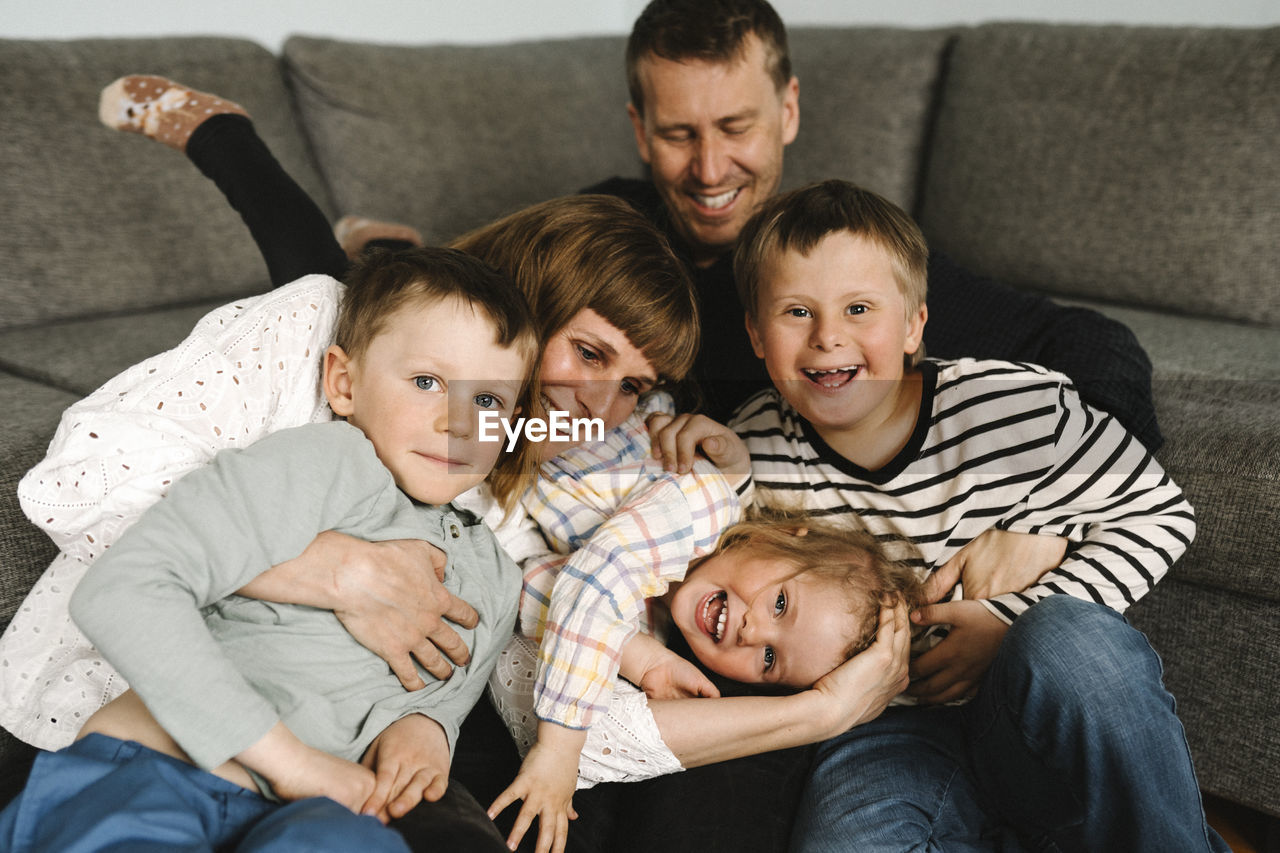 Portrait of happy children spending leisure time with parents at home