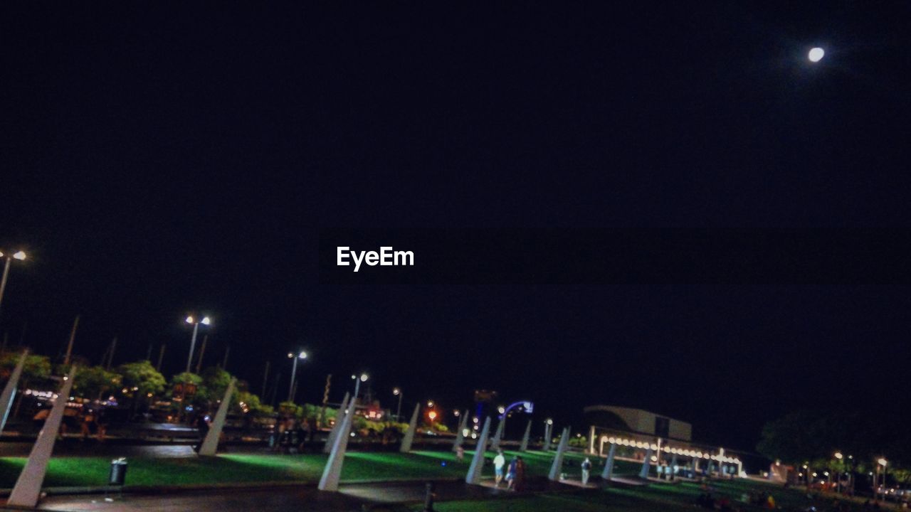 VIEW OF ILLUMINATED STREET LIGHT AGAINST SKY