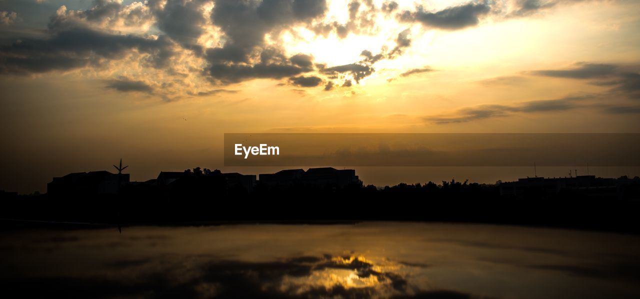 Scenic view of silhouette buildings against sky during sunset