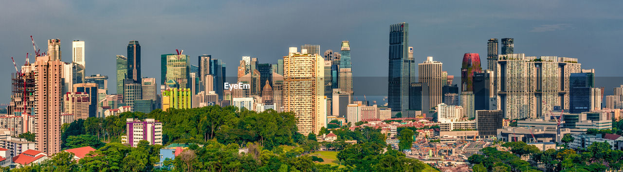 Panoramic view of modern buildings against sky in city