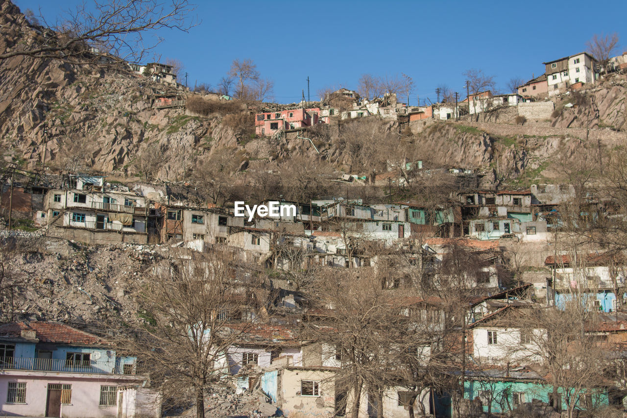 Residential buildings in city against clear sky