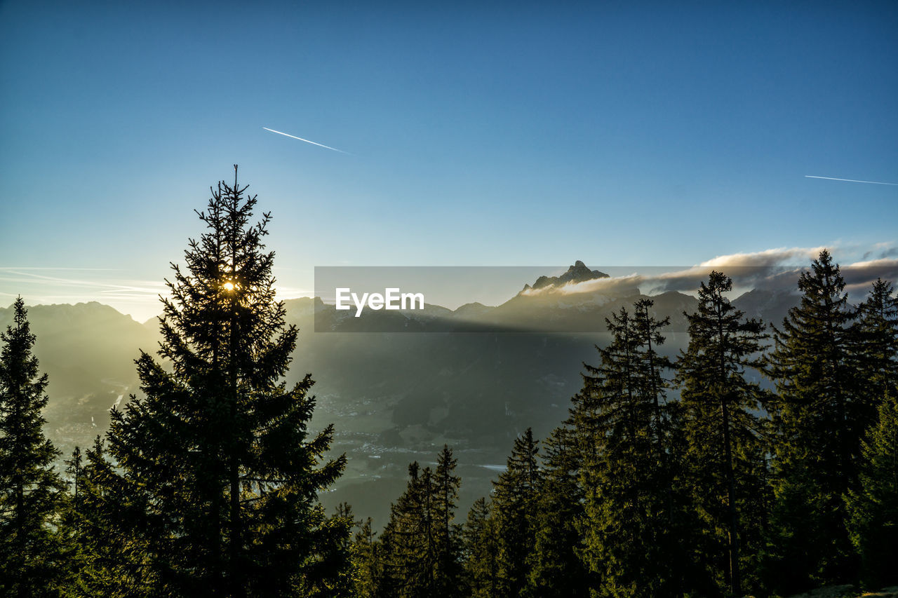 Scenic view of mountains against blue sky