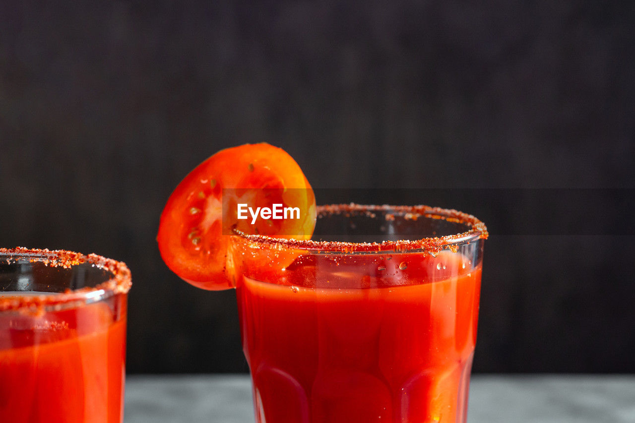 Two refreshing vegetable cocktails. red cocktail. tomato juice served in glass with tomato slice. 