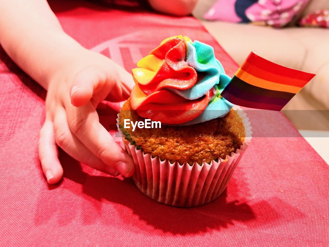 Close-up of hand holding chocolate cake