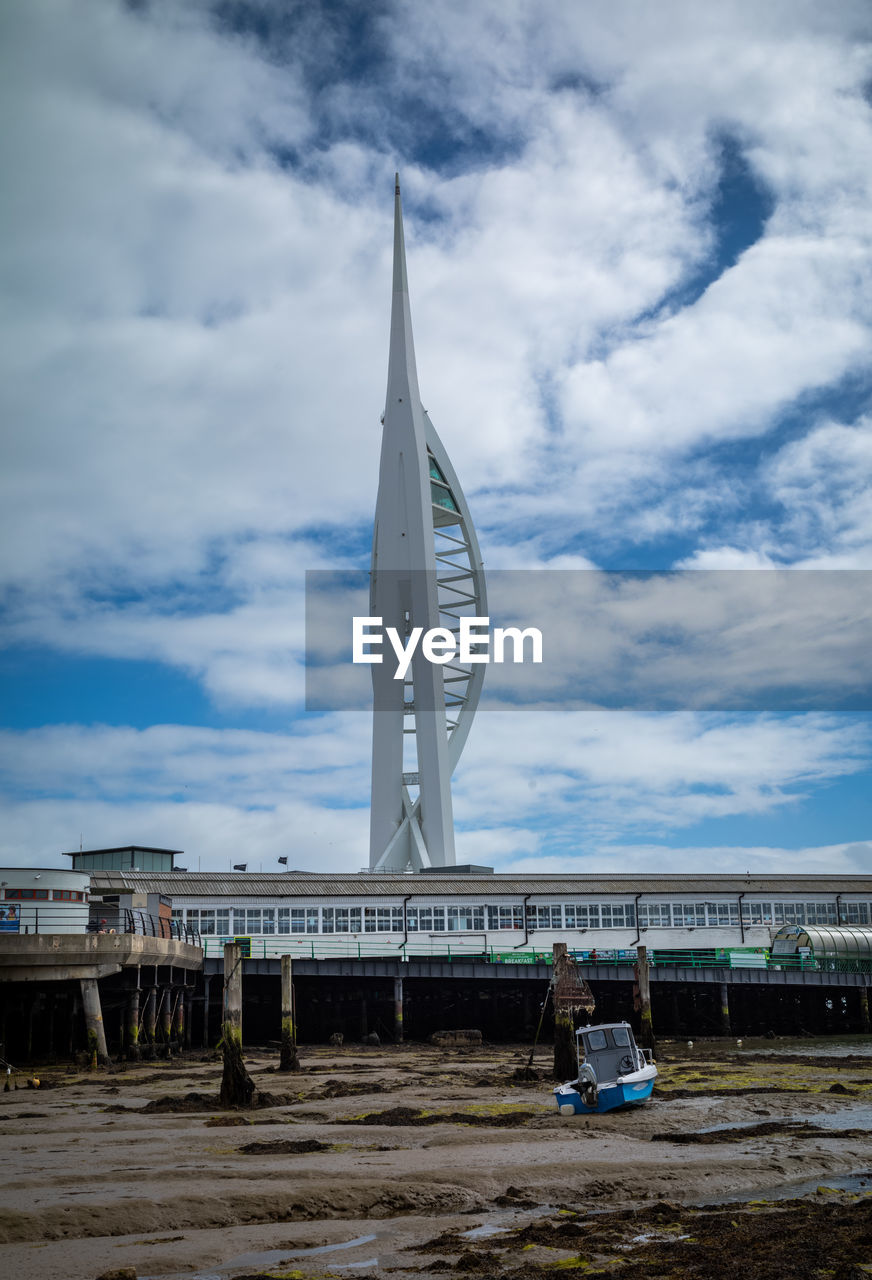 sky, cloud, sea, architecture, built structure, nature, water, tower, day, landmark, no people, vehicle, reflection, blue, mast, ocean, outdoors, transportation, wind, sailing, travel destinations, travel, beach, building exterior, coast, environment