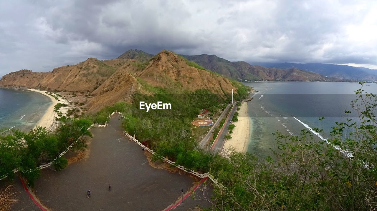 High angle view of river amidst mountains against sky