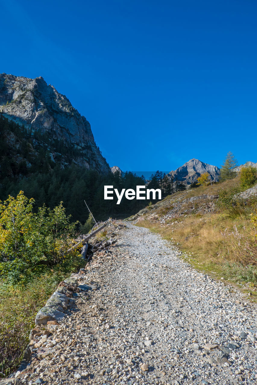 Scenic view of mountains against clear blue sky