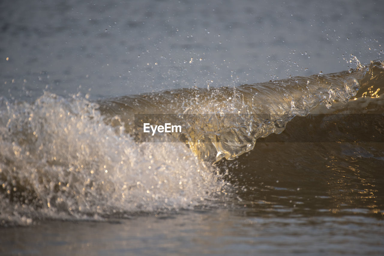 High angle view of waves splashing on shore