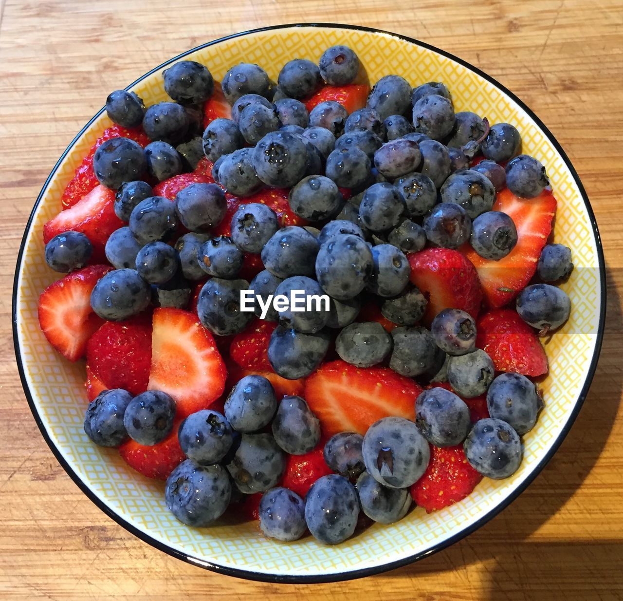 Directly above shot of berry fruits in bowl on table