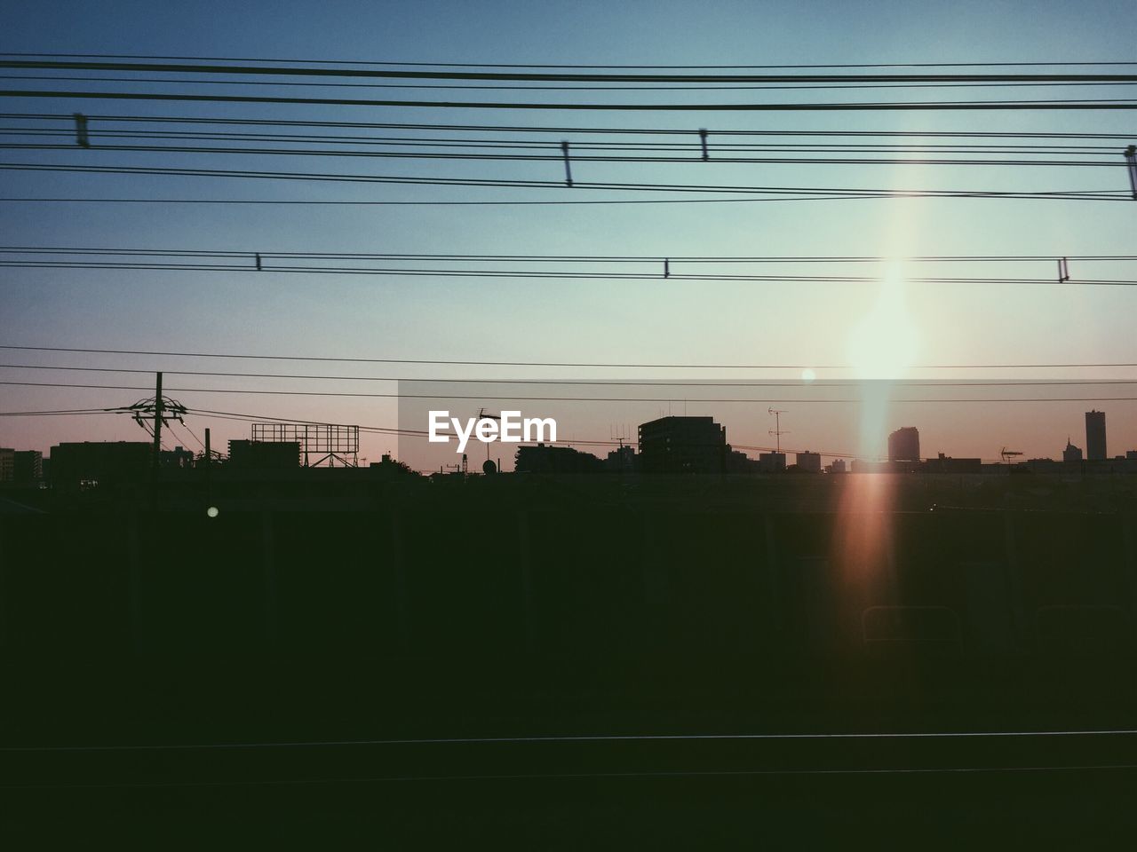 Silhouette of city and railroad tracks