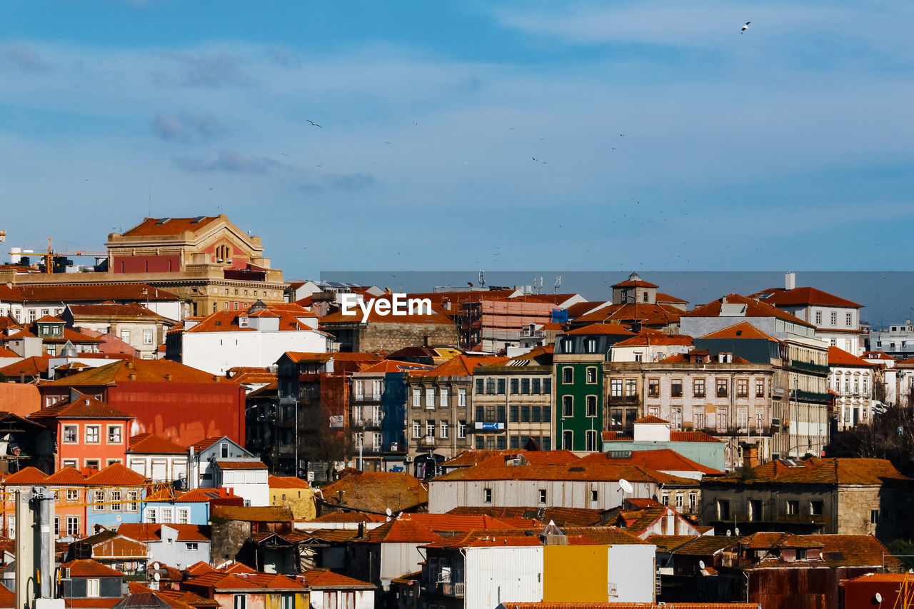 Buildings in city against sky