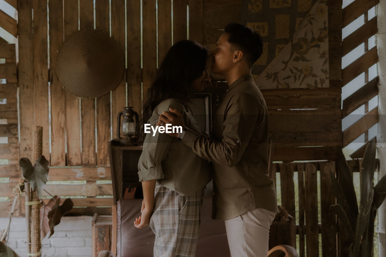 Side view of couple standing outdoors