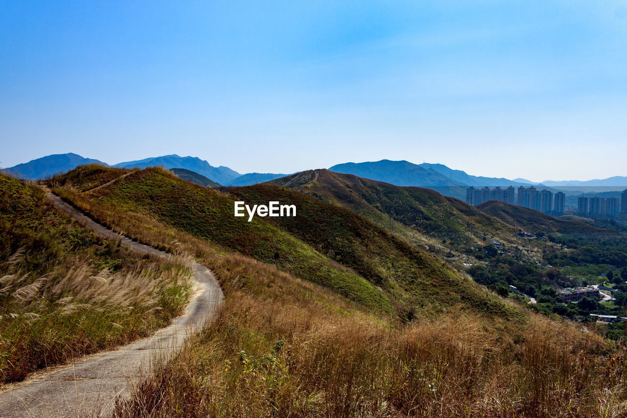 MOUNTAIN ROAD AGAINST BLUE SKY