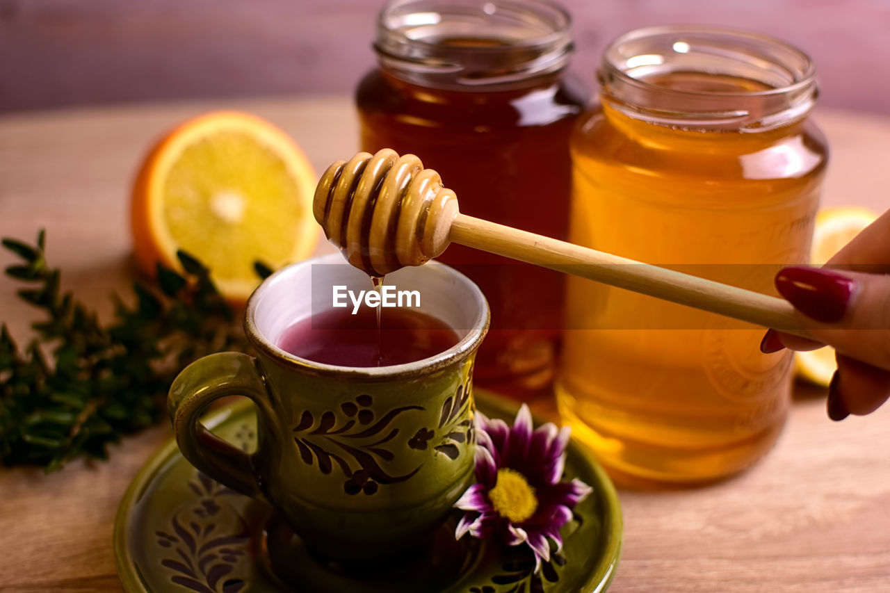 Close-up of tea cup on table with honey