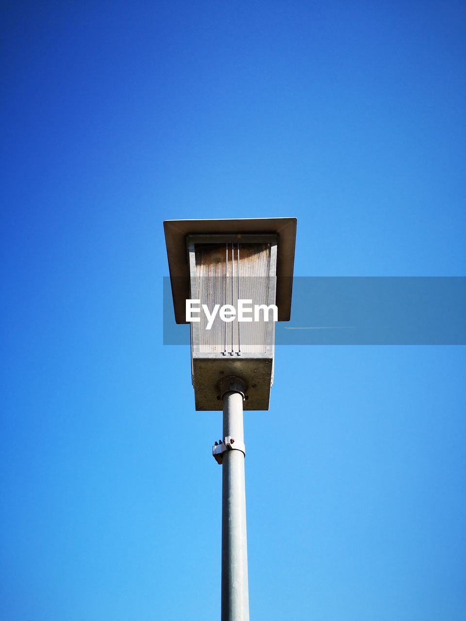 Low angle view of street light against clear blue sky