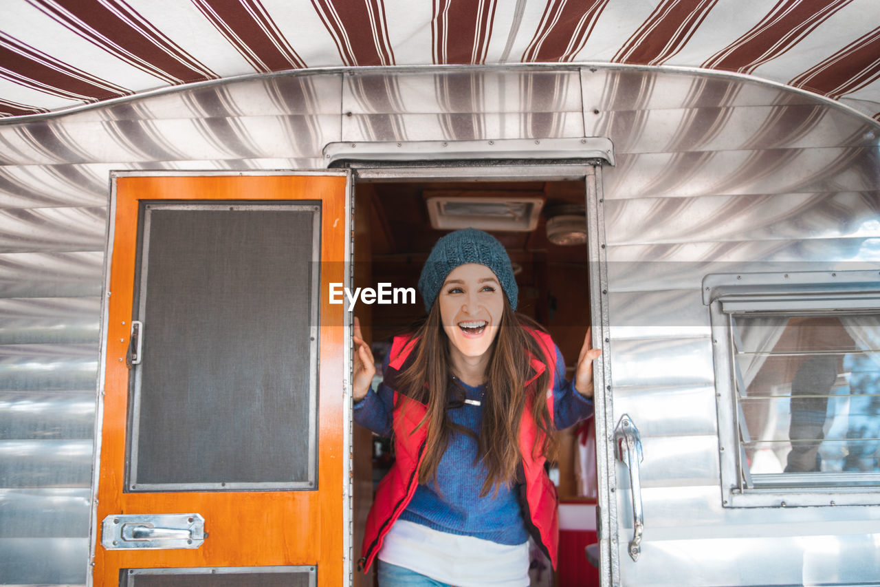 Cheerful woman standing in vehicle trailer