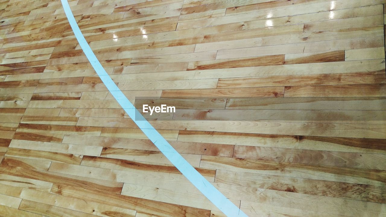 High angle view of wooden floor in basketball court