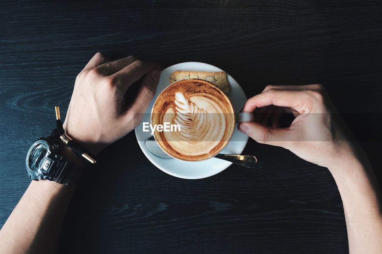 High angle view on man with coffee cup on table