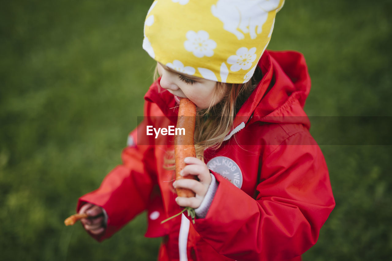 Girl eating carrot