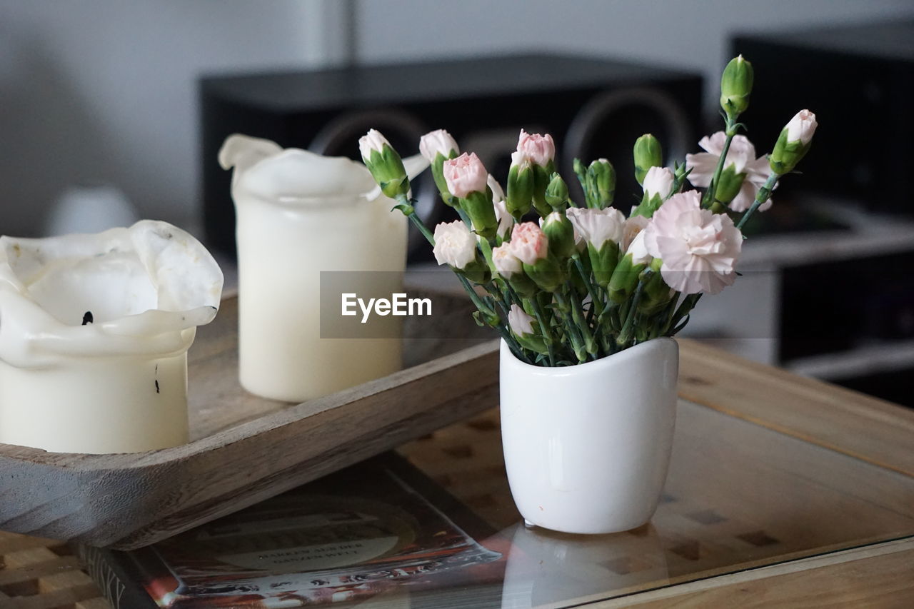 Close-up of white flower pot on table at home