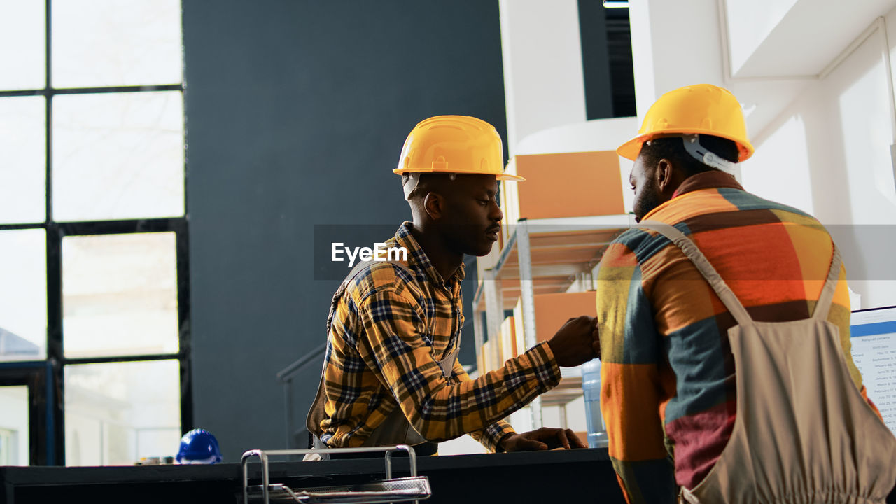 rear view of man working at factory