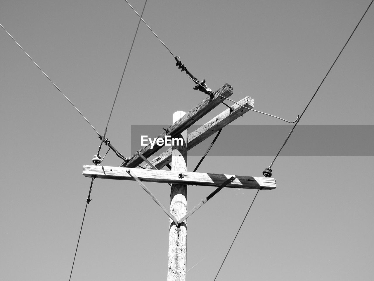 Low angle view of electricity pylon against sky