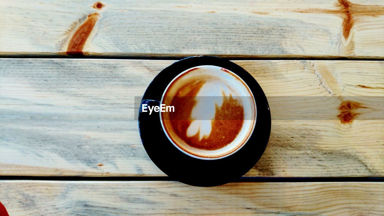 CLOSE-UP OF CAPPUCCINO ON TABLE