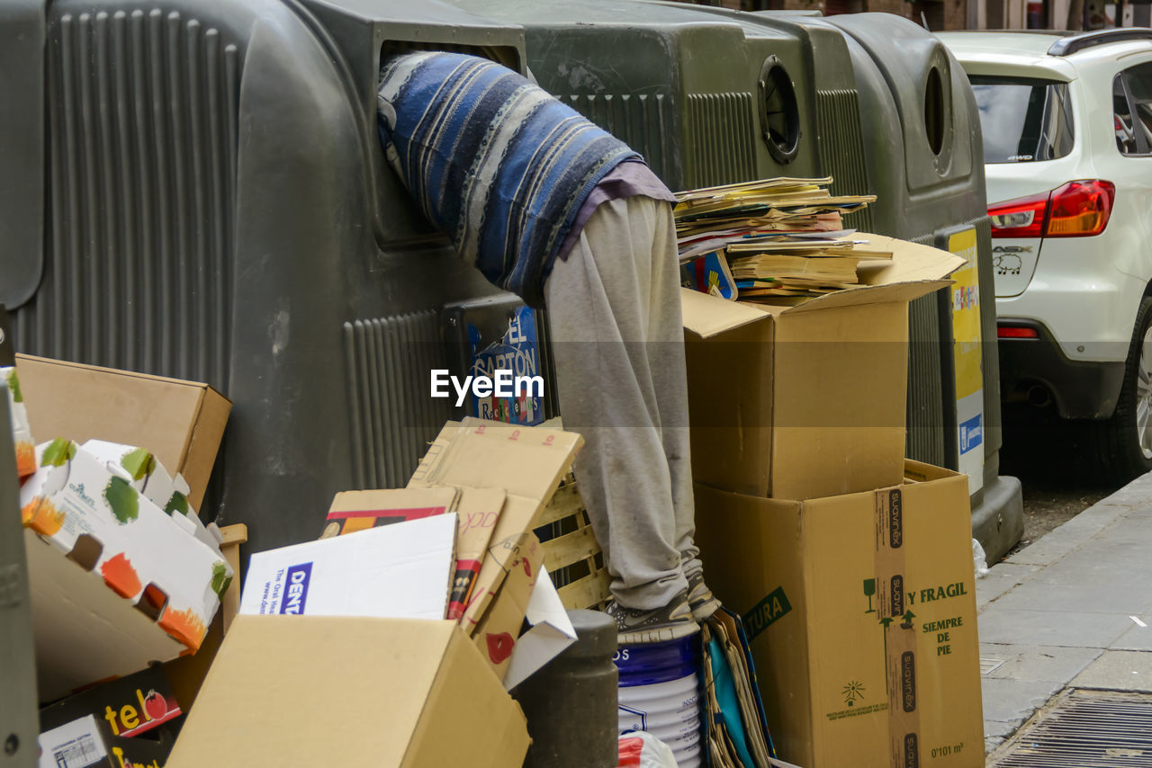 Man with cardboard waste on roadside