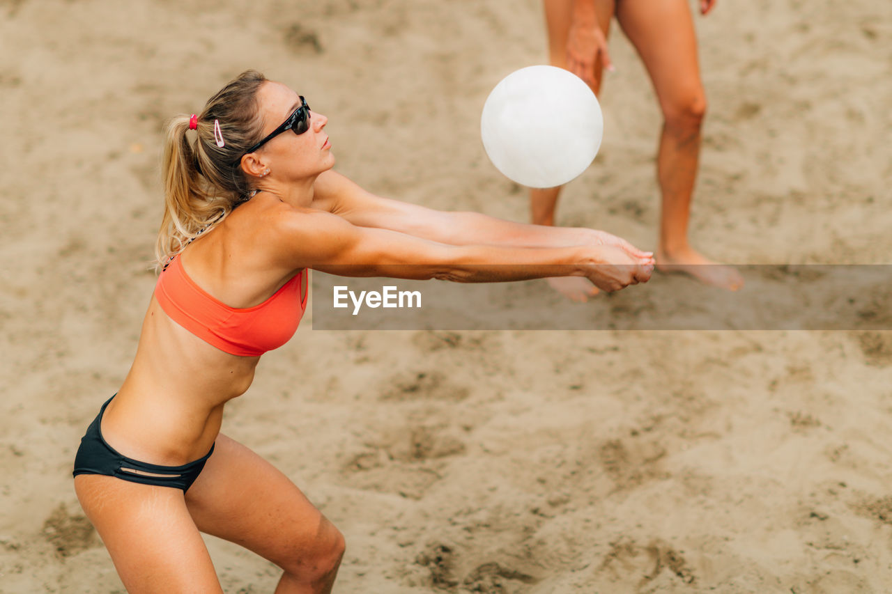 Beach volleyball player hitting the ball