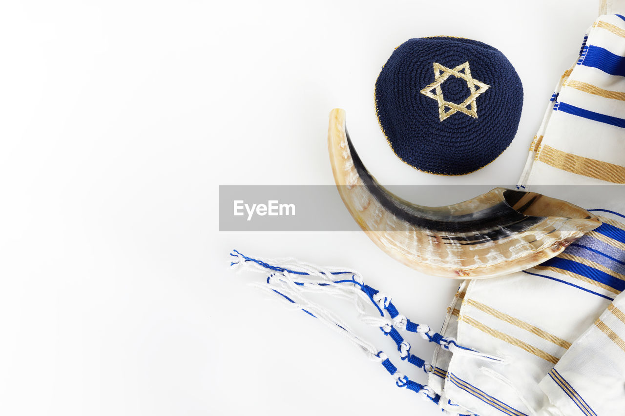 HIGH ANGLE VIEW OF HAT ON TABLE AGAINST WHITE WALL