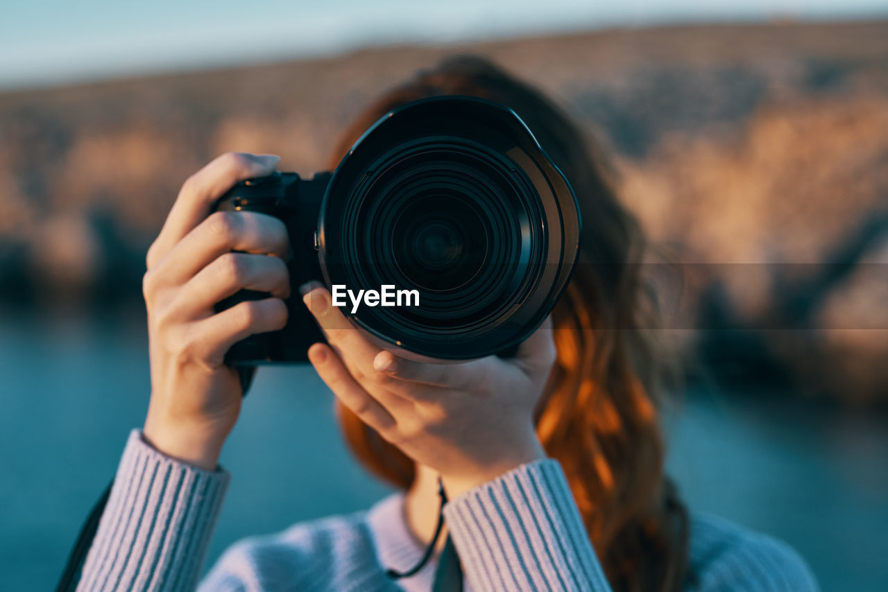 Portrait of woman photographing