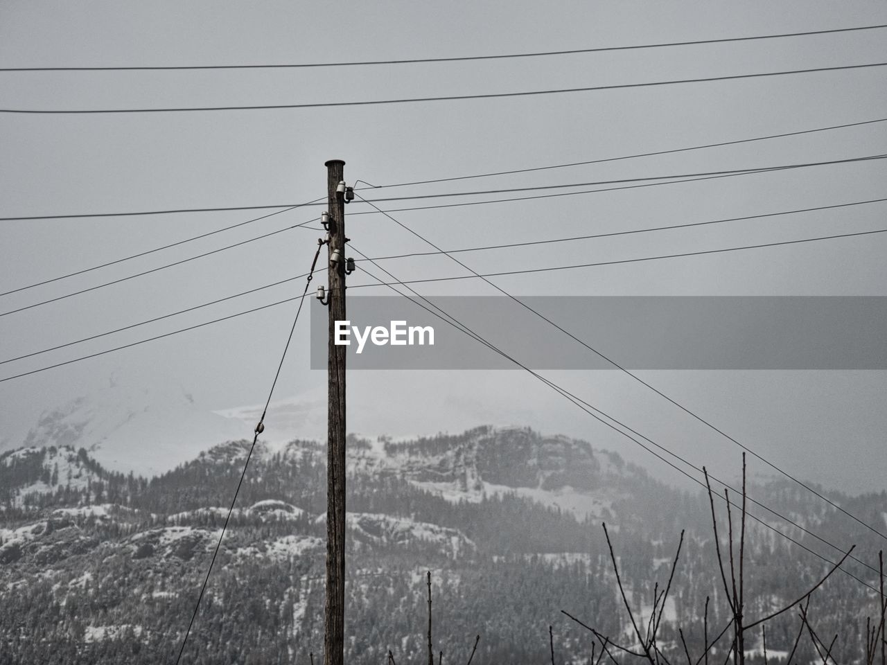 Low angle view of power lines against clear sky