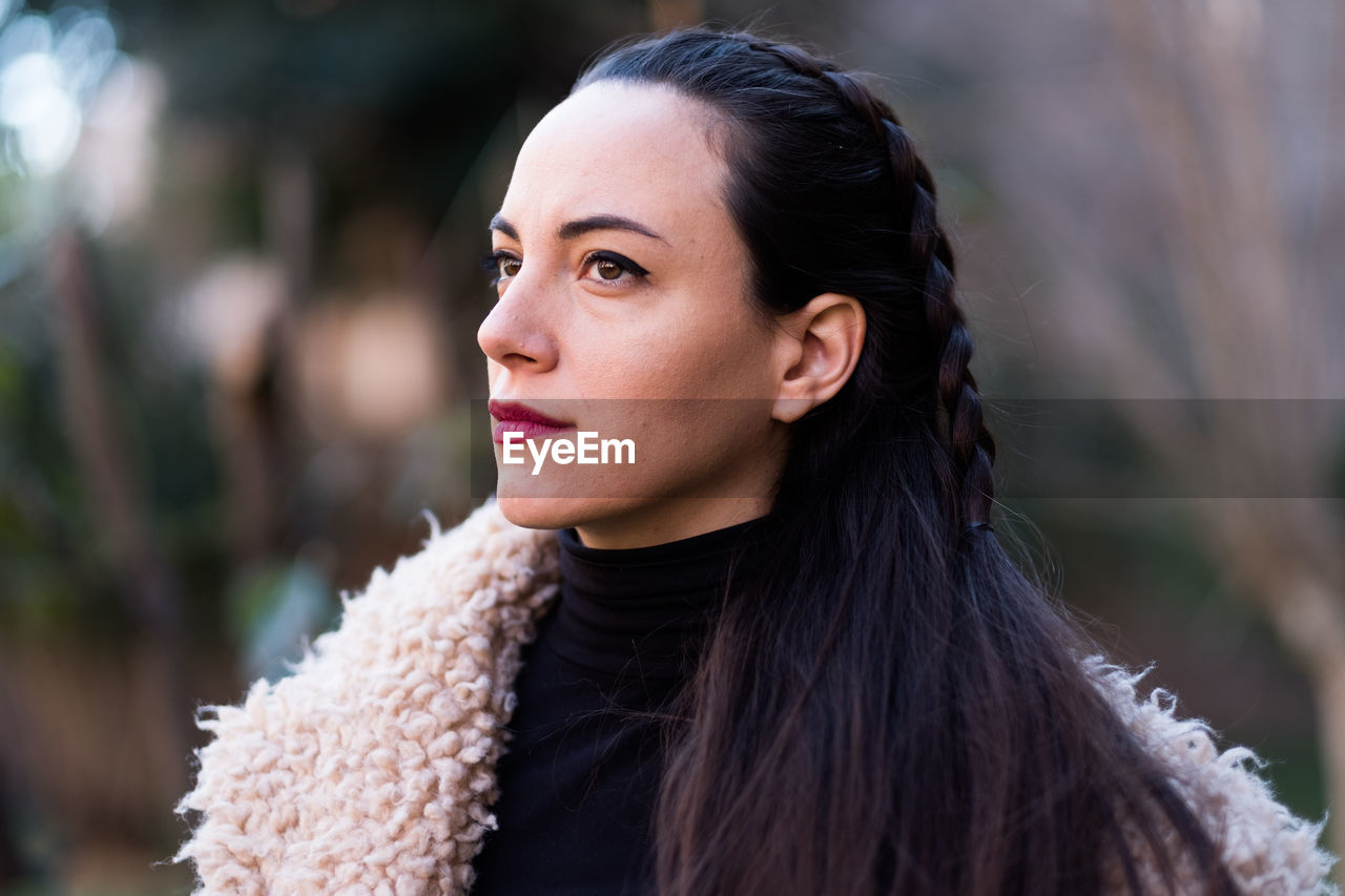 Thoughtful young woman looking away