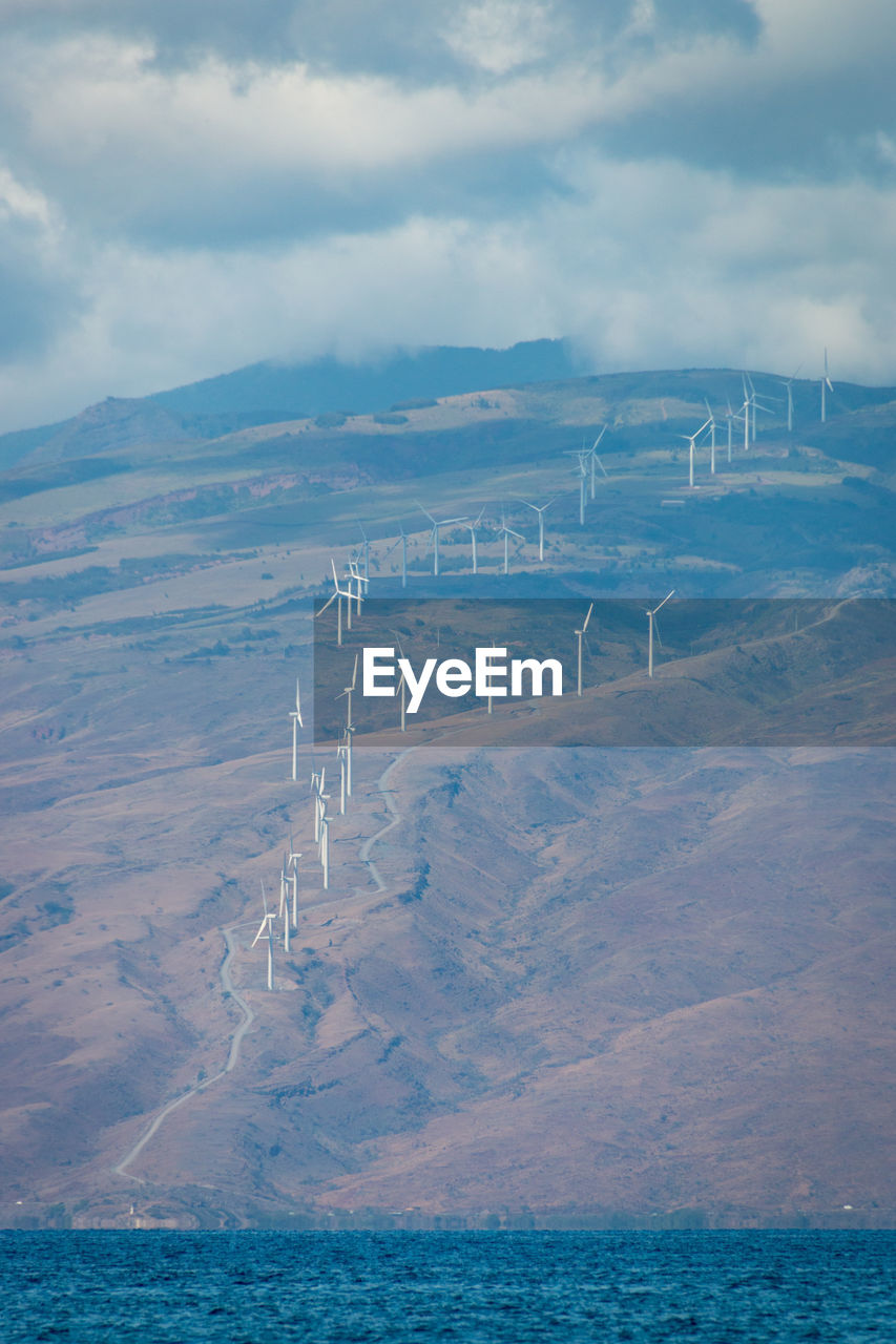 Modern windmills on the hawaiian island of maui generating clean energy