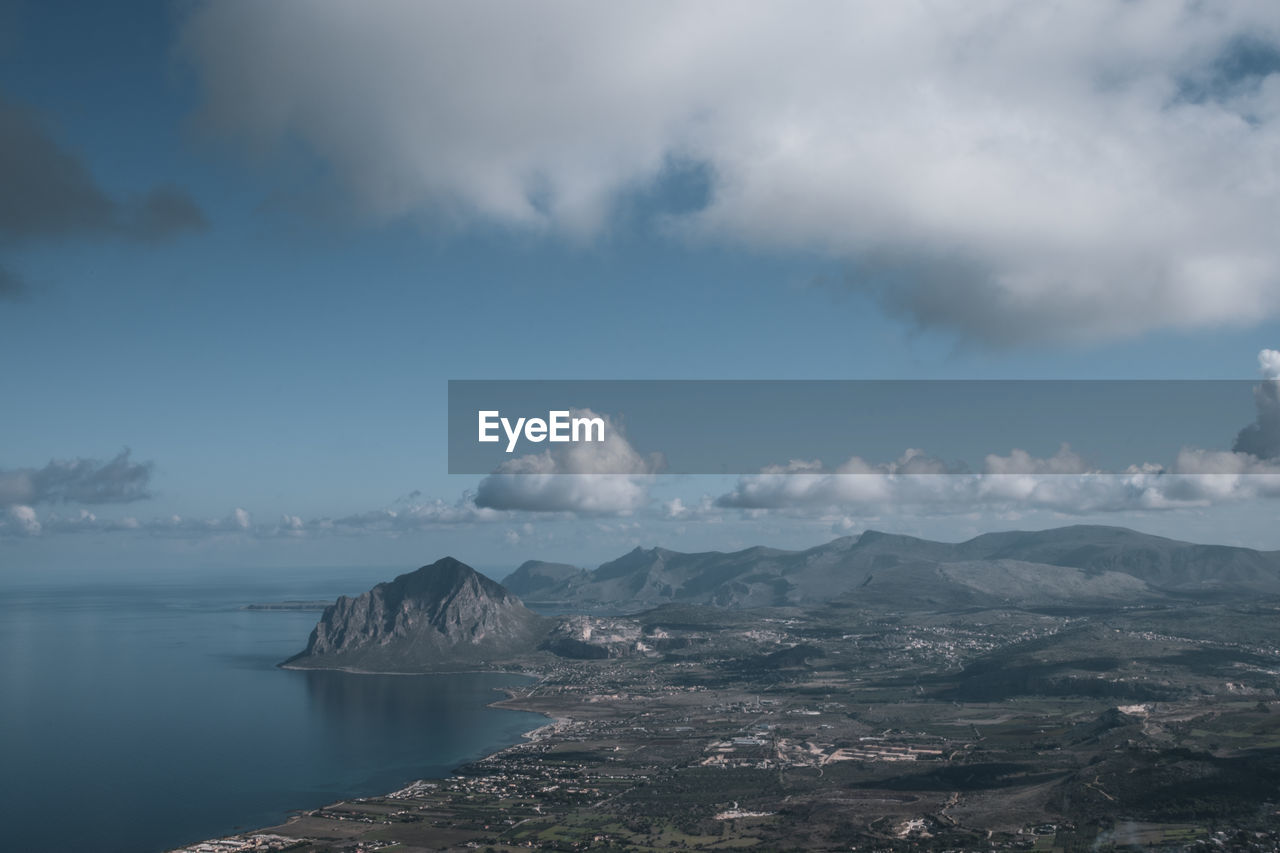 Scenic view of sea and mountains against sky