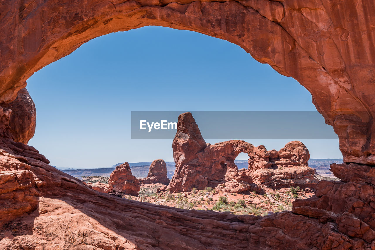 Rock formations against clear blue sky