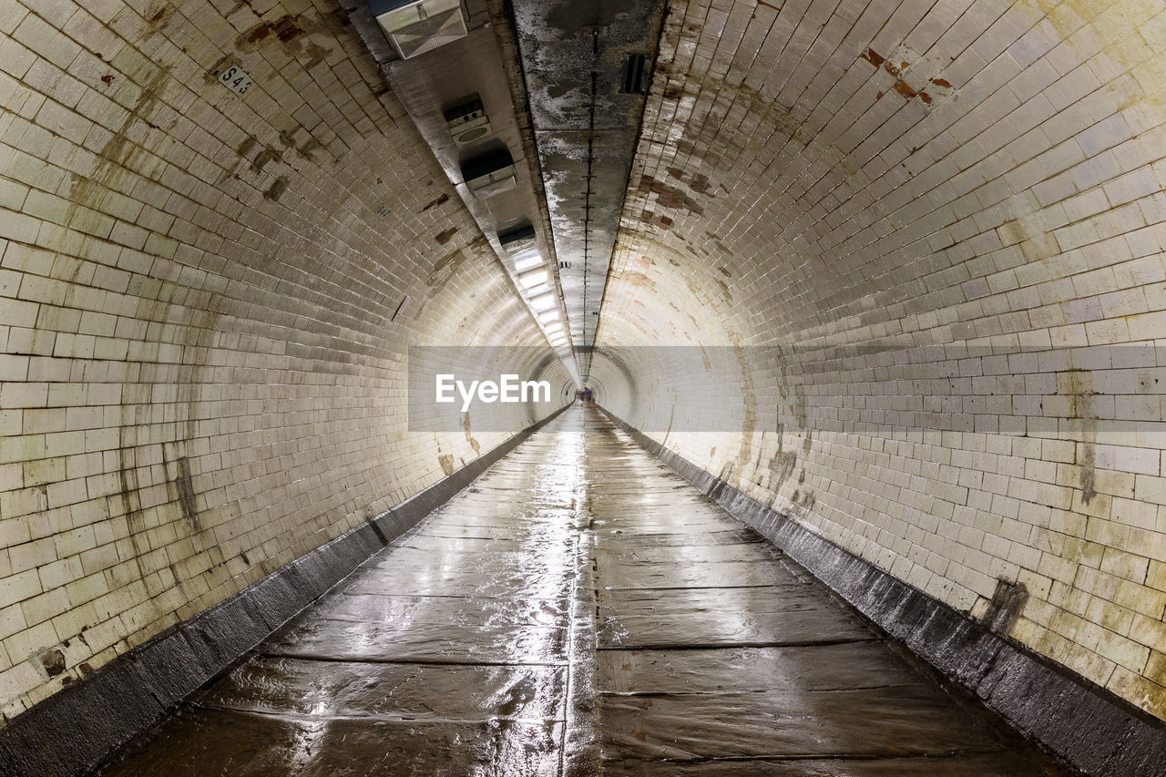 The greenwich foot tunnel crosses beneath the river thames in london