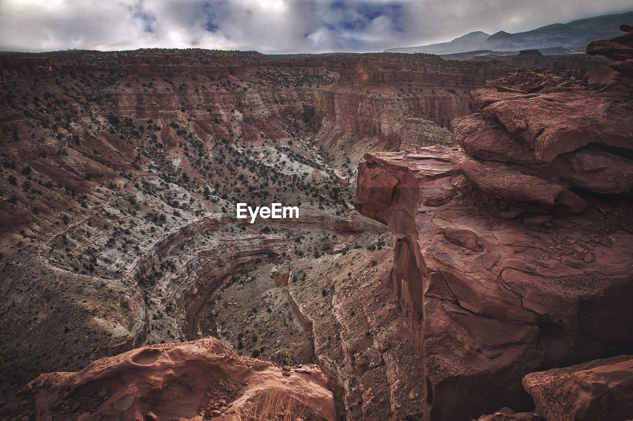 View of rock formation against cloudy sky