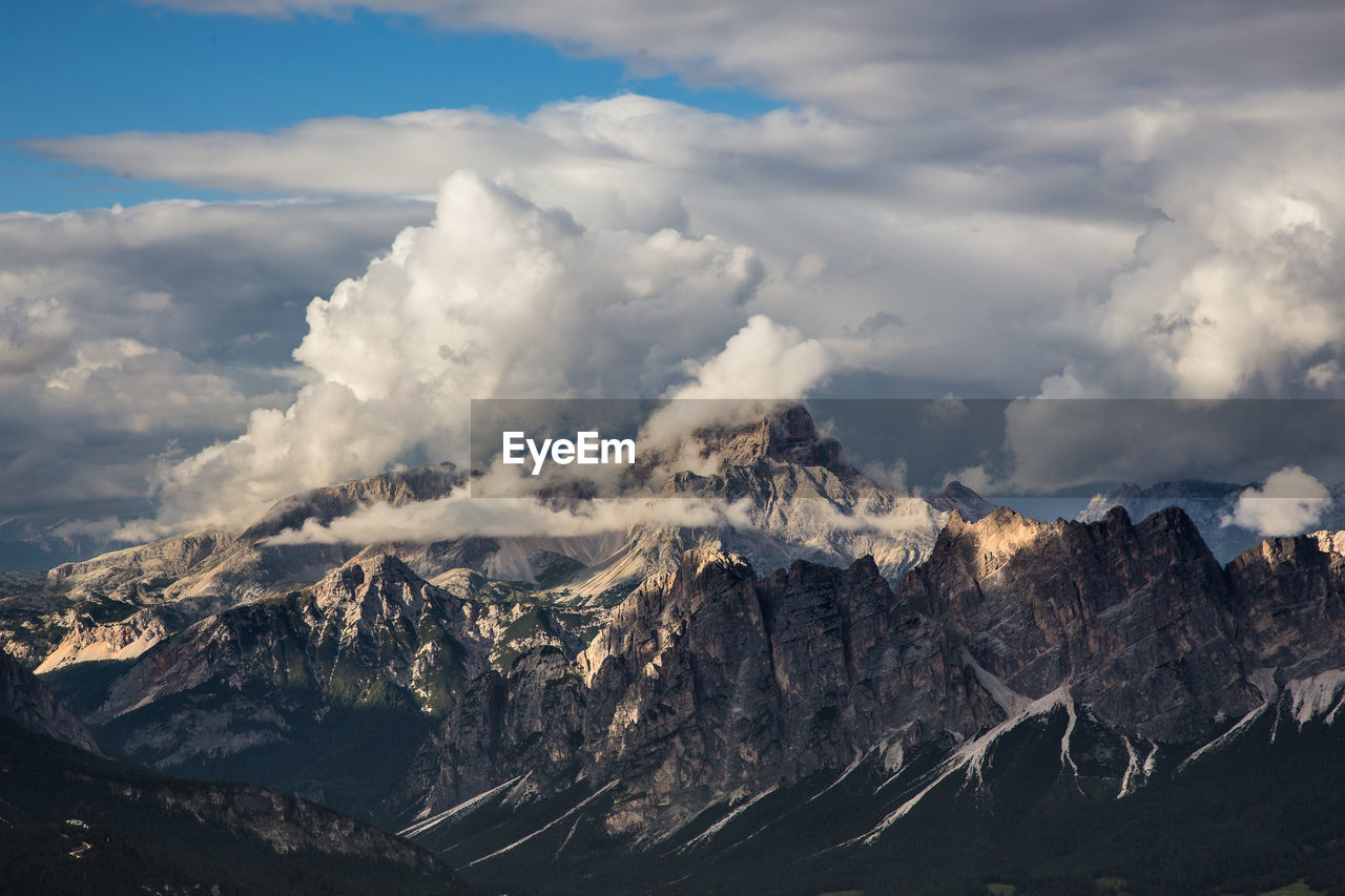 Scenic view of dolomites against cloudy sky