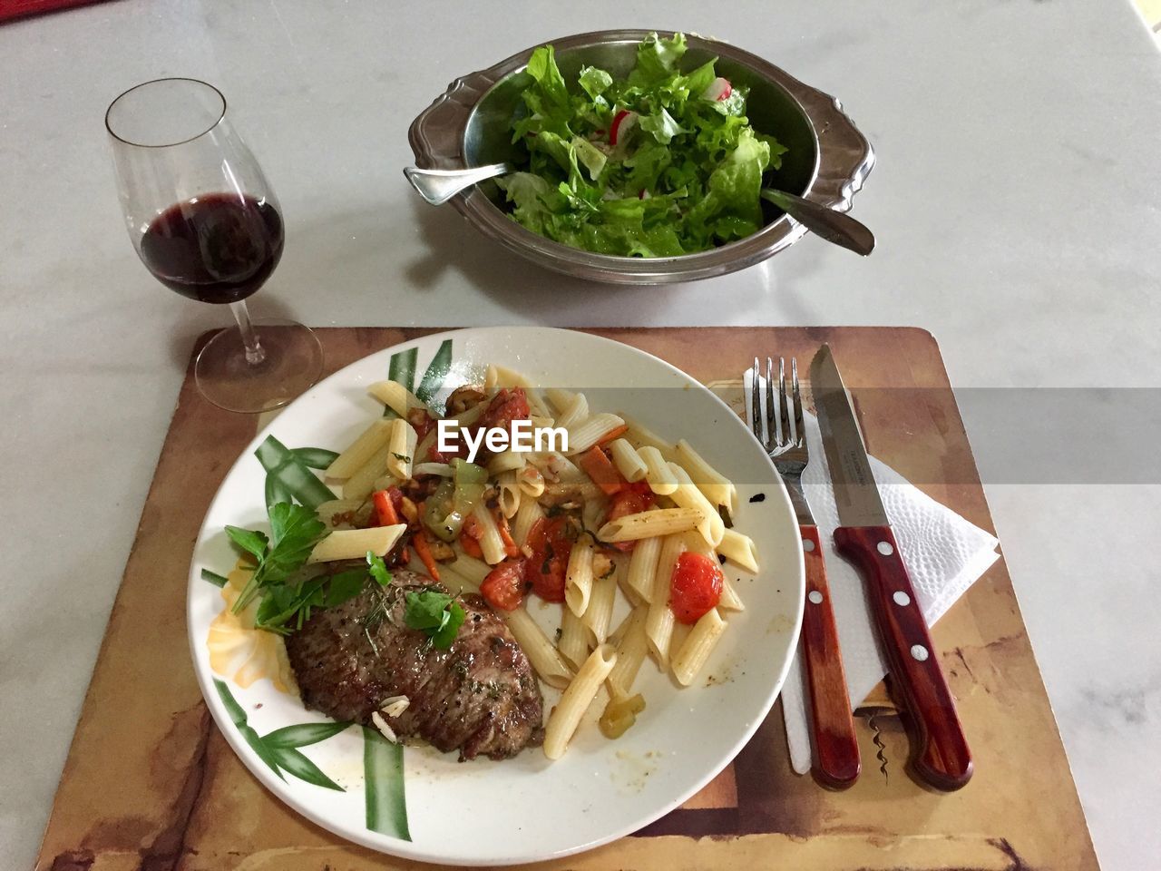 HIGH ANGLE VIEW OF SALAD SERVED ON TABLE