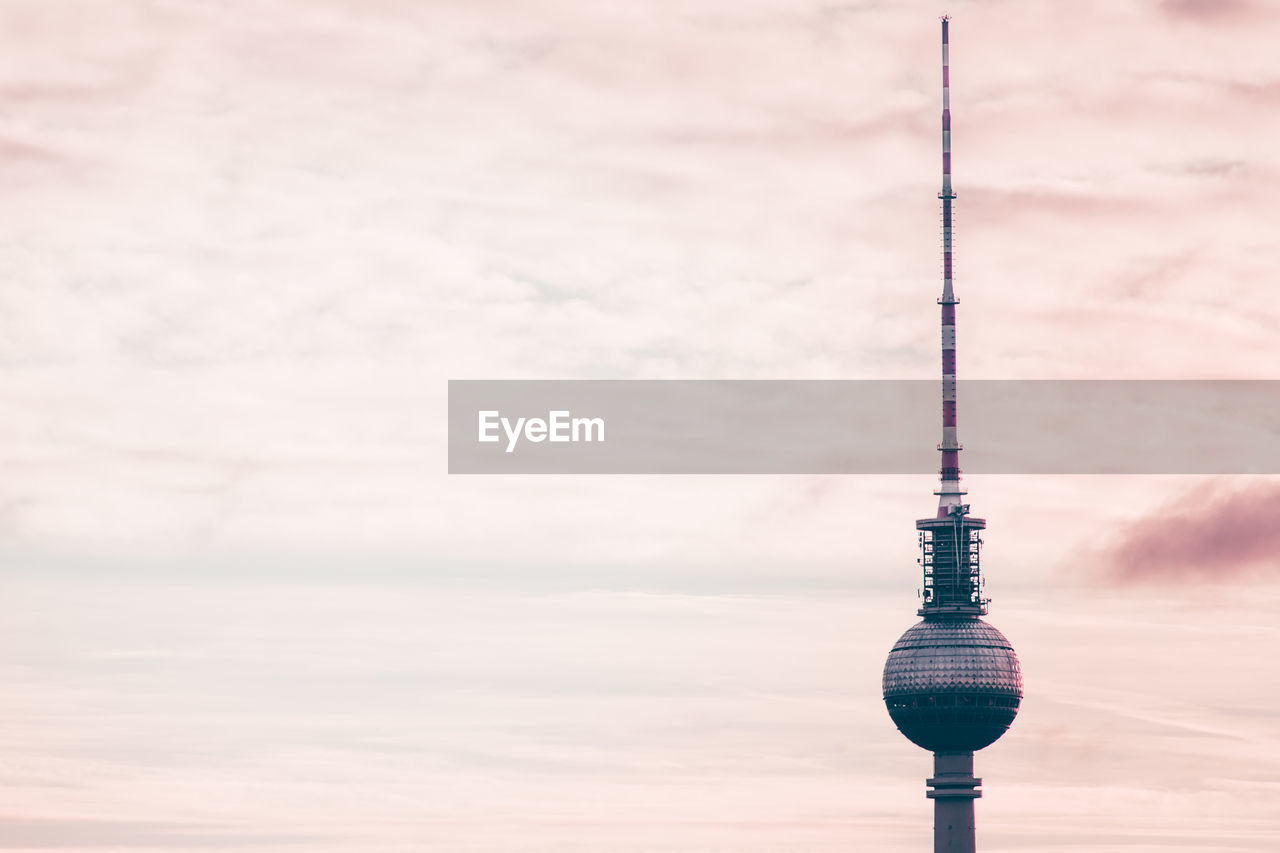 Low angle view of fernsehturm against sky during sunset